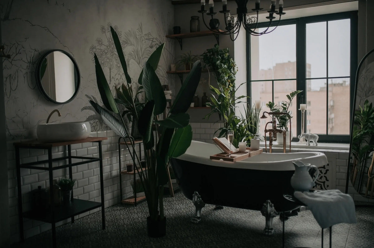 Modern bathroom with a freestanding bathtub, tropical houseplants and a north-facing window