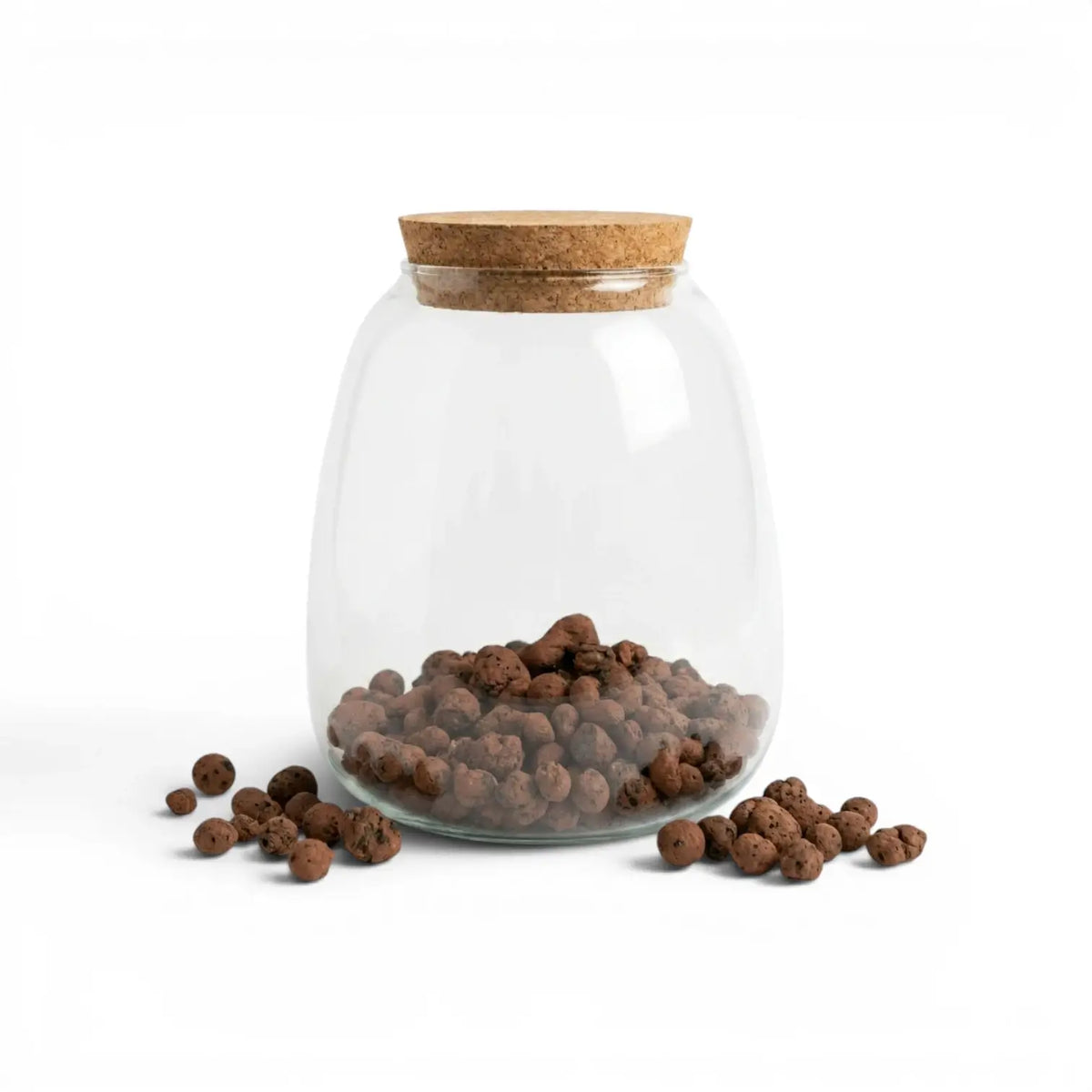 Glass jar with cork lid filled with expanded clay pebbles on a white background