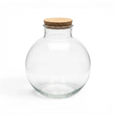 Clear glass jar  Bowl with a cork lid on a white background