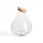 Clear glass jar Drop with a cork  lid on a white background