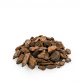 Heap of brown pine bark chips on a white background
